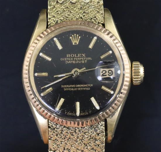 A ladys 18ct gold Oyster Perpetual Datejust Superlative Chronometer, having black dial with baton numerals (bracelet repaired)